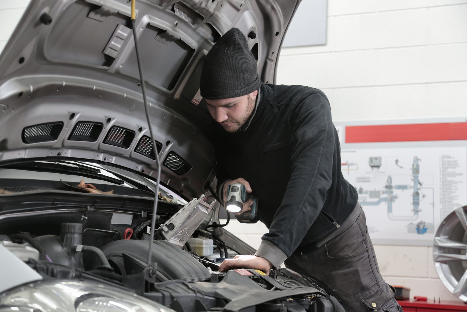 Technician inspecting a semi truck engine bay