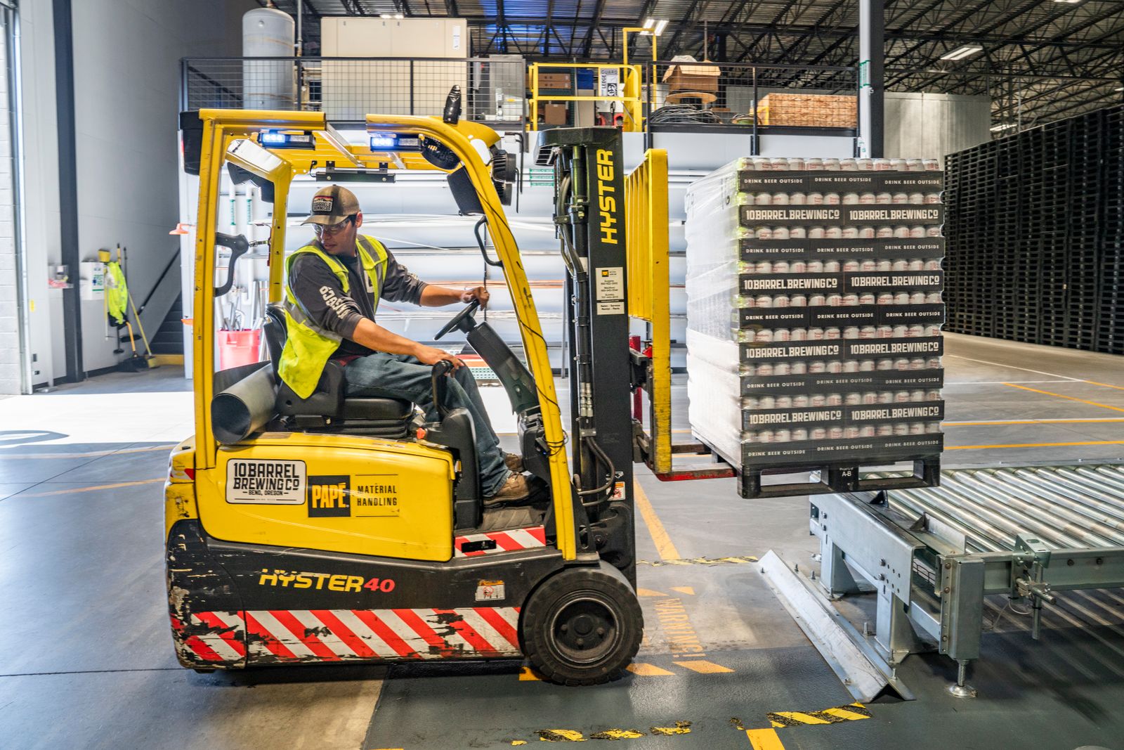 Forklift loading palletized freight in a distribution warehouse
